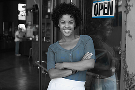 Smiling Woman in Front of Small Business